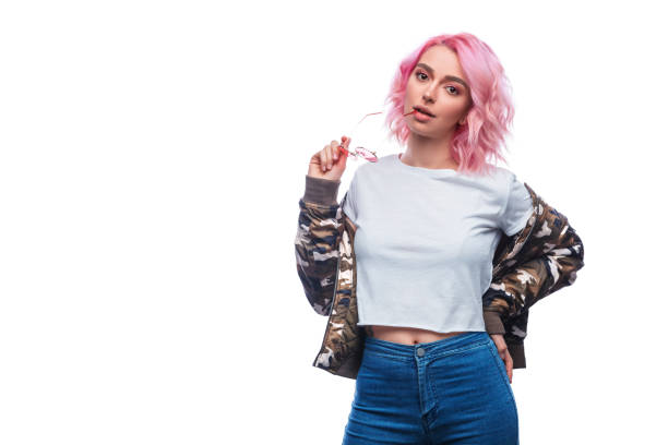 Stylish hipster woman with pink hairstyle Pretty modern woman with pink dyed hair wearing casual attire and posing with sunglasses isolated on white background pink hair stock pictures, royalty-free photos & images