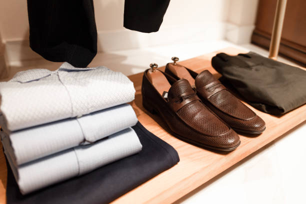 Stylish men's clothing and shoes in a clothing store Stylish men's clothing and shoes in a clothing store mens fashion stock pictures, royalty-free photos & images