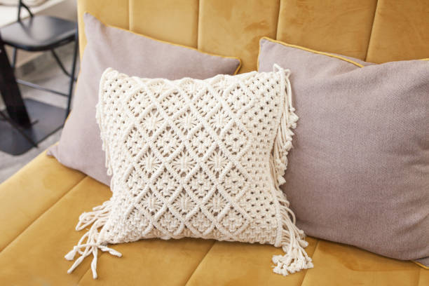 Stylish pillow in the interior. Macram decor lifestyle. Eco style. Natural cotton stock photo