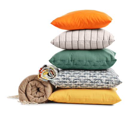 Stylish soft pillows and blankets on white background