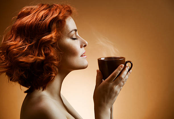 Stylish woman with an aromatic coffee in hands stock photo