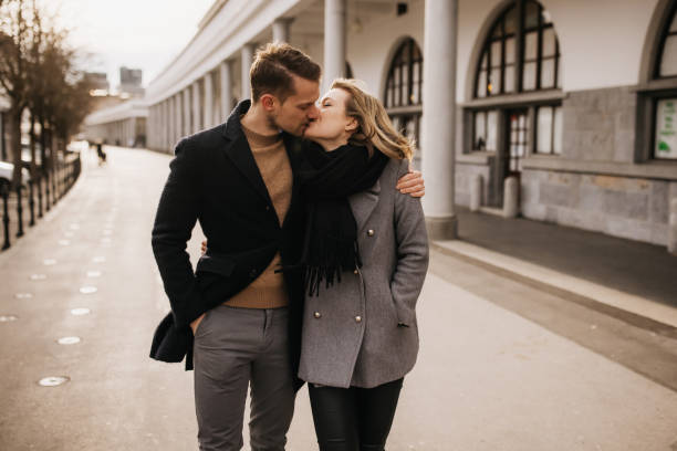 Stylish young couple kissing in a historical urban surroundings stock photo