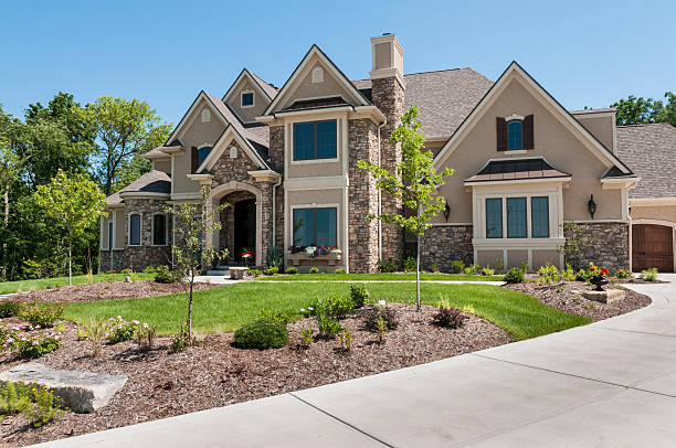Suburban Home Exterior Front elevation of a large contemporary home. stone house stock pictures, royalty-free photos & images