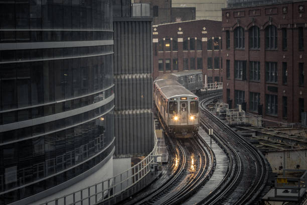 Subway train rounding corner on elevated tracks in downtown Chicago stock photo