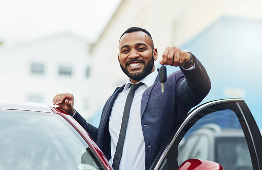 Shot of a well-dressed man holding the keys to his new car