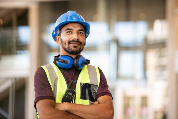 Successful construction site worker thinking stock photo