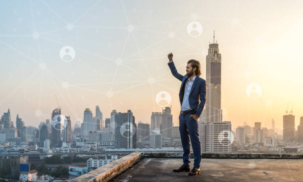 Successfull business in suit on rooftop with city scape in the background. People networking success, stock photo