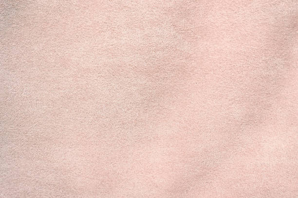 Suede is artificial. Light pink suede fabric close-up. Velvet texture background stock photo