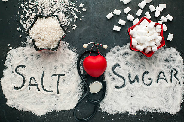 Sugar and salt brings harm to the heart. stock photo