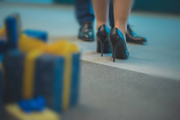 Sugar daddy bringing gifts to a sexy female in high heels. Conce stock photo
