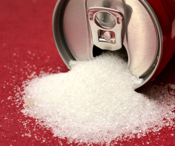 sugar pouring out from alluminium can, health concept stock photo