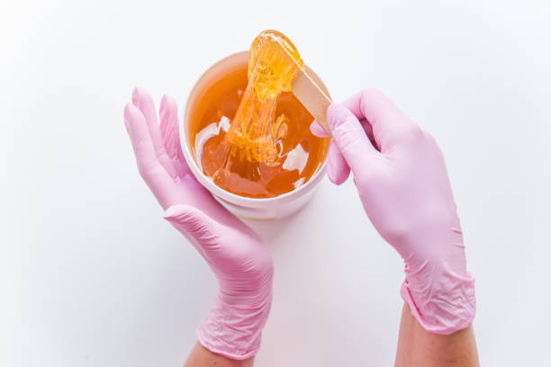 sugaring concept. flat lay. overhead view of bowl with cosmetology honey stock photo