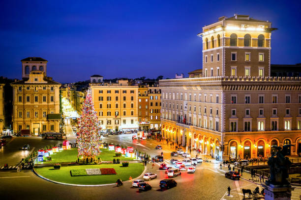 A suggestive night view of Piazza Venezia in the heart of Rome with a large Christmas tree stock photo