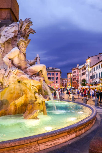 A suggestive view of the Four Rivers Fountain in Piazza Navona in the baroque heart of Rome stock photo