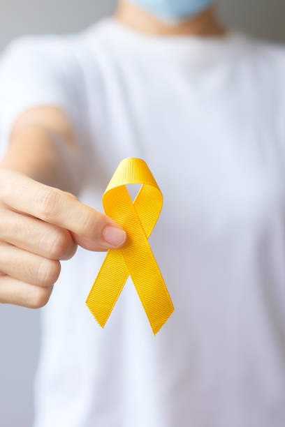 Suicide prevention day, Sarcoma, bone, bladder and Childhood cancer Awareness month, Yellow Ribbon for supporting people living and illness. children Healthcare and World cancer day concept stock photo