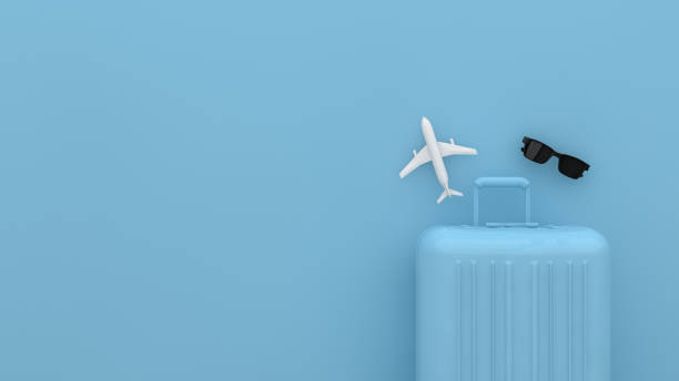 スーツケース、青い背景、夏または冬のシーズンとの最小限の旅行コンセプト。