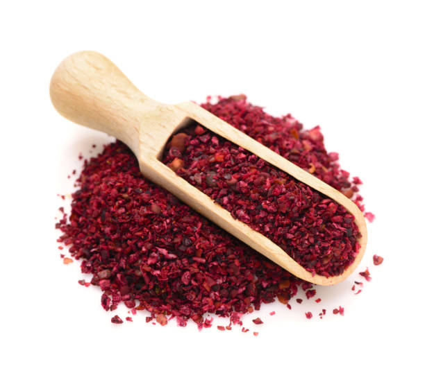 Sumac in a wooden scoop for spices stock photo