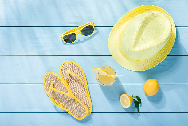 Summer accessories on blue wooden background top view stock photo