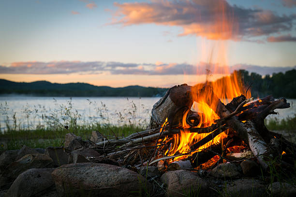 Summer Campfire and Lake at sunset Summer Campfire at sunset Campfire stock pictures, royalty-free photos & images