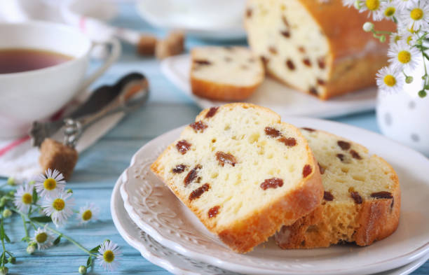 Summer dessert. Raisin cake and two cups of tea, rustic style stock photo