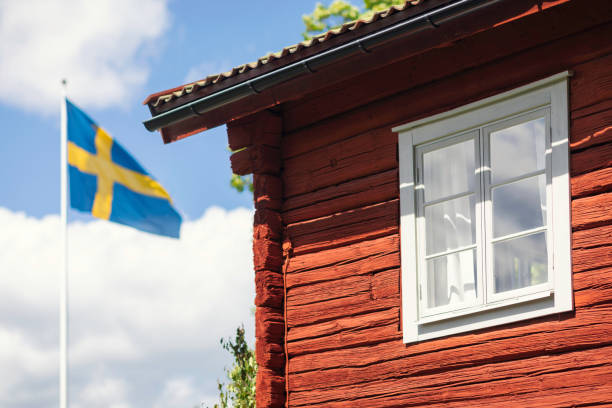 Summer holiday in Sweden Detail of a country house and a swedish flag on midsummer's eve. swedish flag photos stock pictures, royalty-free photos & images