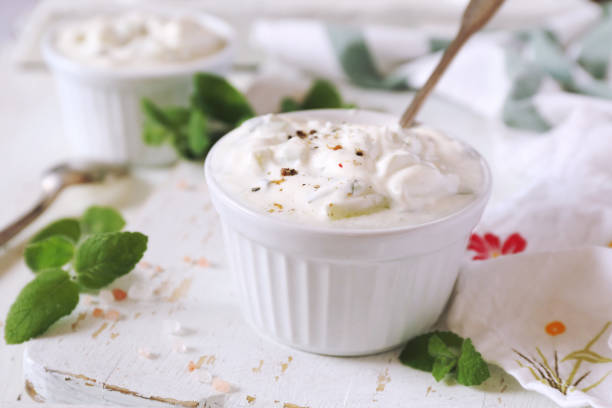 Summer light salad: Greek yogurt, garlic, mint and cucumber stock photo