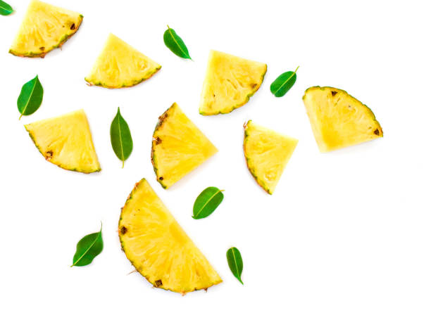 Summer Pattern with Slices of Pineapple Isolated. Exotic fruit Pineapple pieces with green mint leaves on white background. Flat lay. Summer Pattern with Slices of Pineapple Isolated. Exotic fruit Pineapple pieces with green mint leaves on white background. Flat lay. pineapple stock pictures, royalty-free photos & images
