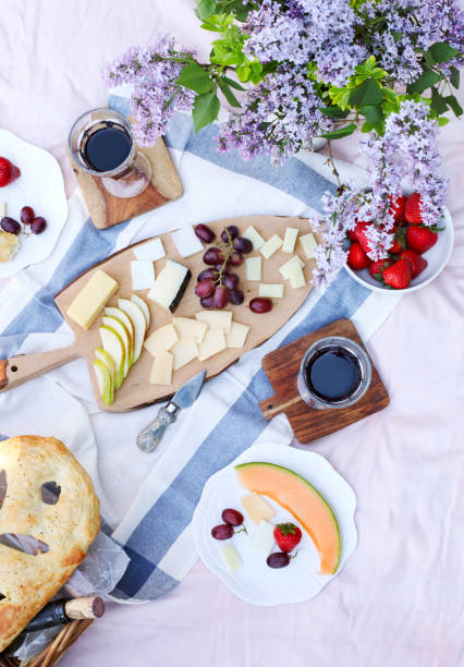 Summer picnic with cheese, wine, fruits and bread. stock photo