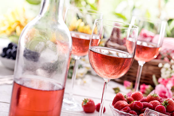 Summer Rose Wine Rose wine on a picnic table. rose wine stock pictures, royalty-free photos & images