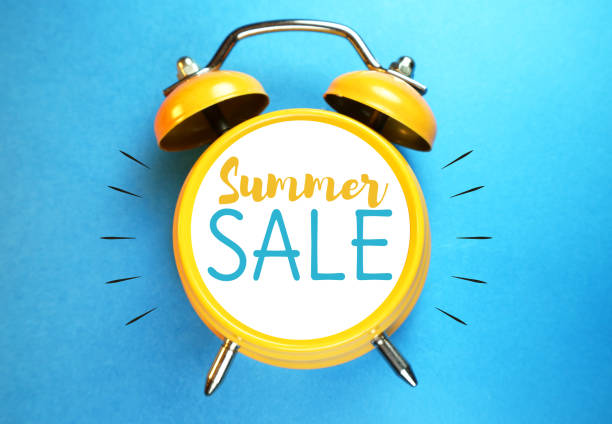 Summer sale concept. Alarm clock with sale message. stock photo
