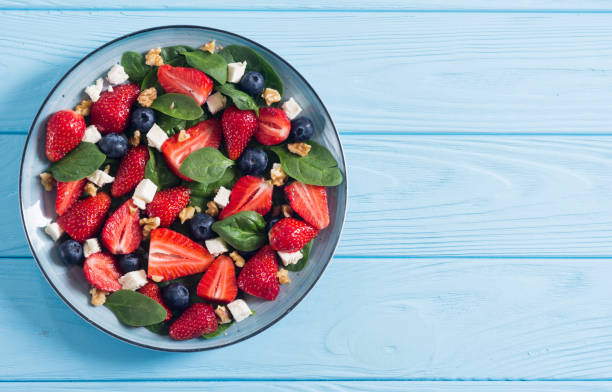 Summer Strawberry salad with spinach , cheese , nuts and blueberry stock photo