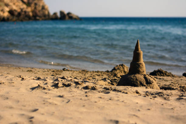 Summer time with sandcastle on the seashore stock photo
