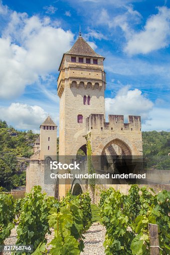 istock Summer view of medieval stone Valentre Bridge with vineyard in Cahors, France 821768746