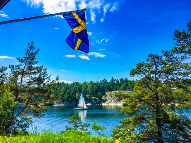 Summer with flag and sailing boat in Stokholm Archipelago stock photo
