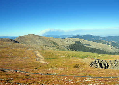 Front Range of the Rocky Mountains, Arapaho National Forest, Colorado, USA: summit flats, scenic byway road and  mountain panorama, looking east from Mount Evans. At 4,350 meters (14,264 feet) Mount Evans is the highest and most famous mountain in the Front Range.