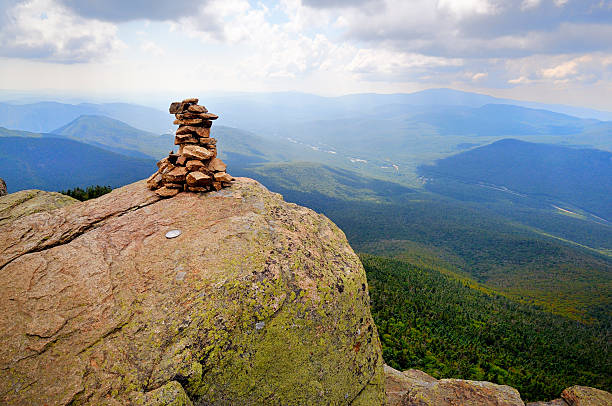 Summit of Mt. Liberty on Franconia Ridge The Mt. Liberty summit cairn and survey marker (printed disc embedded in the rock) on the Franconia Range. mike cherim stock pictures, royalty-free photos & images