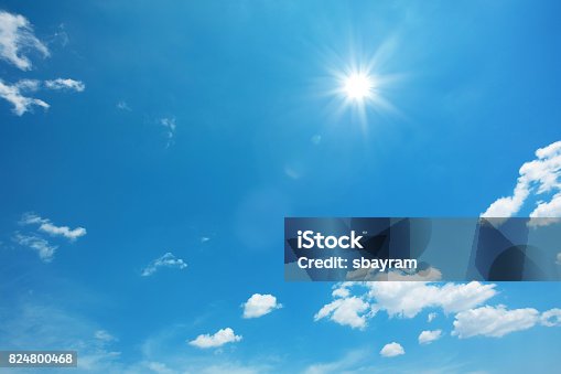 istock Sun on blue sky with clouds 824800468