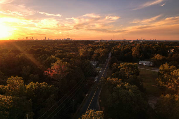 sun sets over the City of Decatur lush with trees stock photo