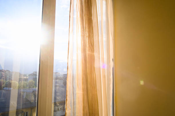 Sun shining through apartment window stock photo