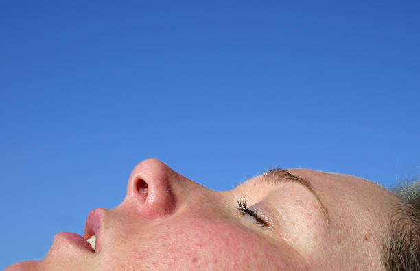 Sunbathing Face Blue Sky stock photo