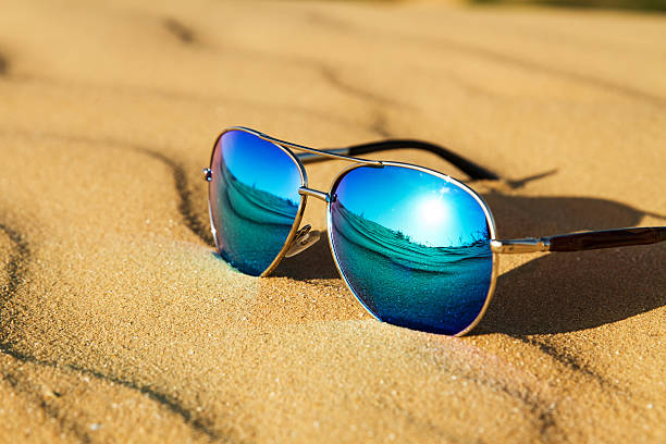 Sunglasses on the sand in the desert. stock photo