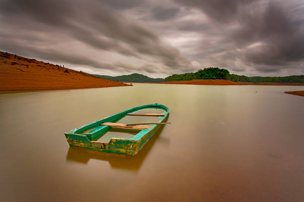 A sunken boat during monsoon A sunken boat during monsoon capsizing stock pictures, royalty-free photos & images