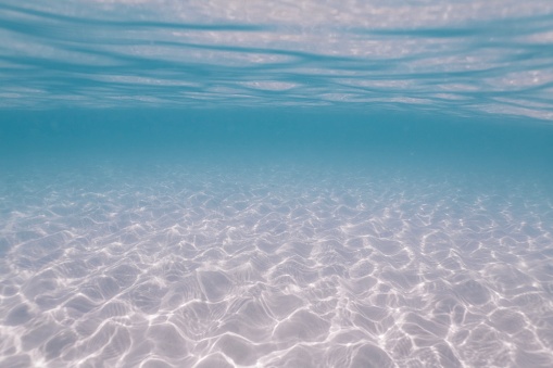 Sunlight On Sandy Sea Floor And Water Surface Stock Photo