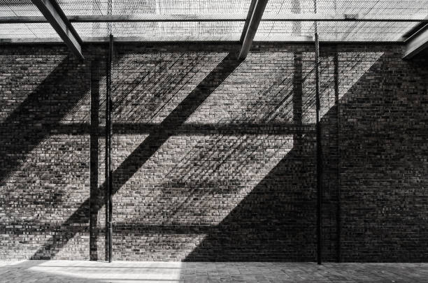 Sunlight pass through the net and reflecting on the brick wall and floor. Sunlight pass through the net and reflecting on the brick wall and floor. concrete wall photos stock pictures, royalty-free photos & images