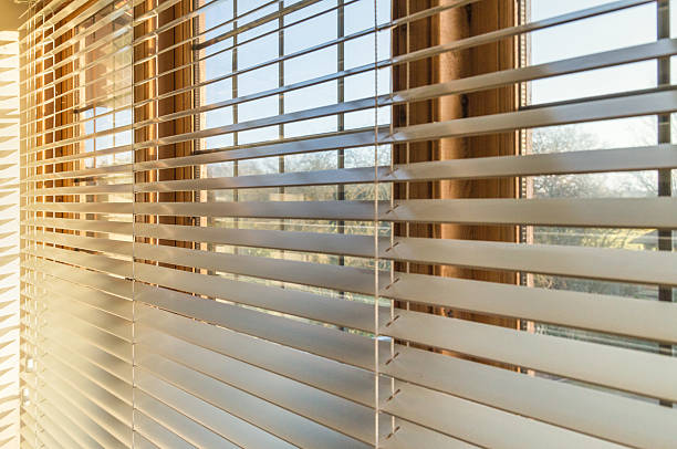 Sunlight through blinds Late afternoon sunlight through blinds roller blinds stock pictures, royalty-free photos & images