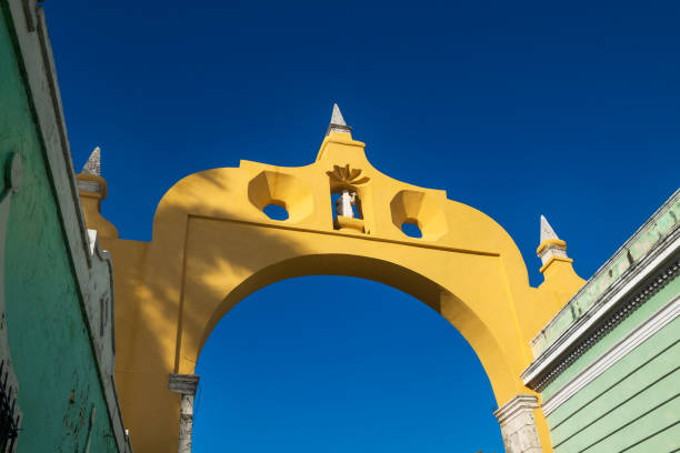 Sunlit colonial arch 'Arc de San Juan' in the historic center of Merida, Mexico stock photo
