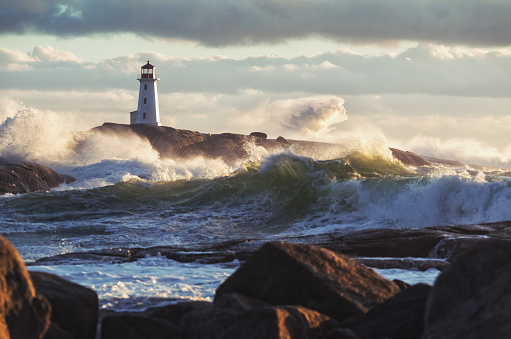 Heavy surf crashes ashore at Peggy's Cove Lighthouse during a strong Autumn storm.