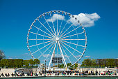 istock Sunny day in a Parisian public park with ferris wheel in a background (Paris, France) 1141052659