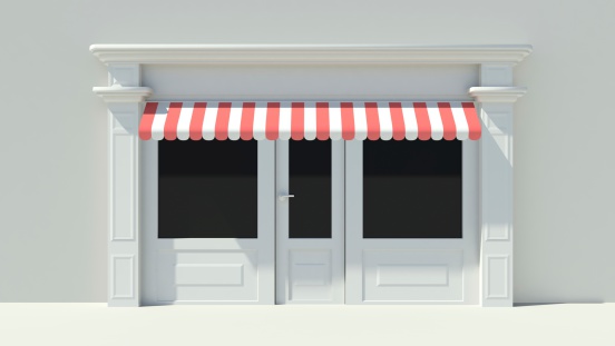 Sunny Shopfront with large windows White store facade with red and white awnings