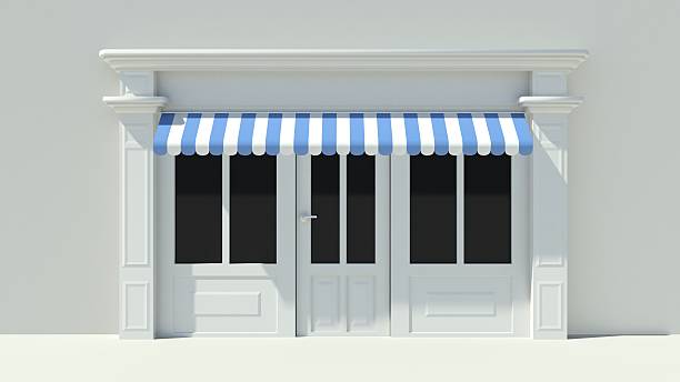 Sunny Shopfront with large windows White store facade Sunny Shopfront with large windows White store facade with blue and white awnings awning window stock pictures, royalty-free photos & images